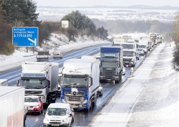 Commuters make their way through the morning rush hour after heavy snow fall on the M8 this morning and the Met Office has warned the weather is likely to get worse this afternoon. Pic: SWNS