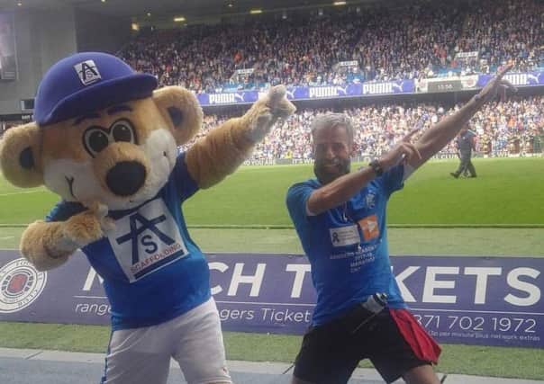 Rangers fan David Smith with club mascot Broxi Bear