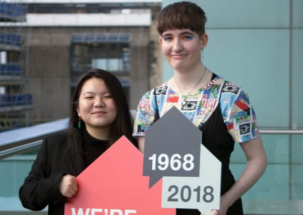 Emily Wang and Sophie Rowan with their wining logo design. Pic: Iain McGuinness / Alamy Live News