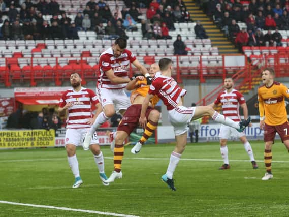 Physical Accies defending thwarts Motherwell striker Curtis Main (Pic by Ian McFadyen)
