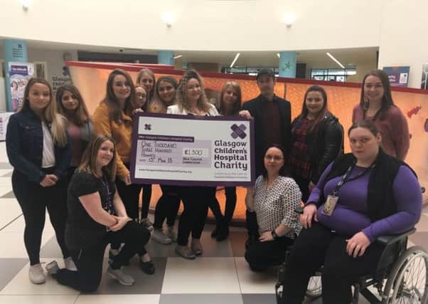 New Lanarkshire College  students handing over the cheque to the hospital