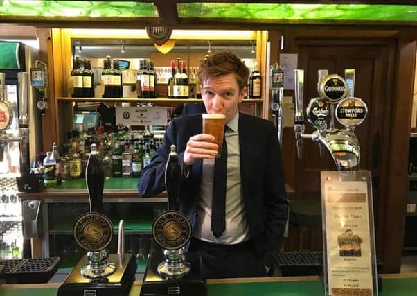 Paul Masterton enjoys a pint in the House of Commons bar.