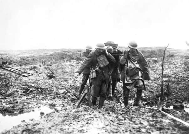 Soldiers carry an injured comrade during the First World Wars battle of Passchendaele