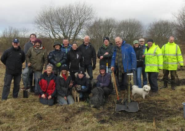 Many hands make lighter work...association members were delighted to welcome so many people to the tree planting event at Loudon Pond last month.