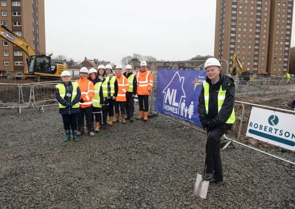 Councillor Allan Graham breaks ground in Draffen Street, Motherwell, watched by Councillor Ann Weir and representatives of  North Lanarkshire Council and Robertson Partnership Homes