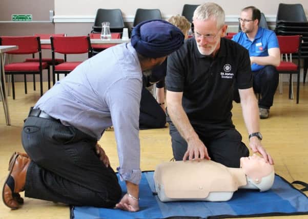 A St John Scotland volunteer delivers CPR training