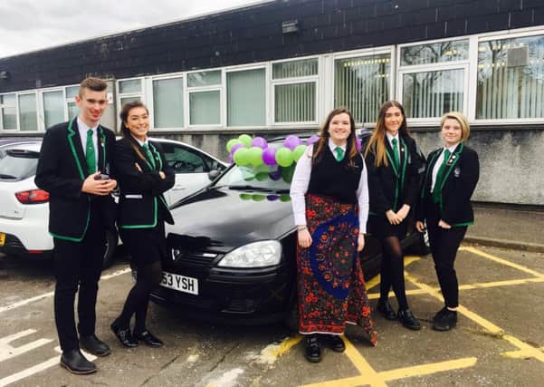Katie McGuckin and members of the Malawi Committee at St. Maurice's High with the car that is being raffled off