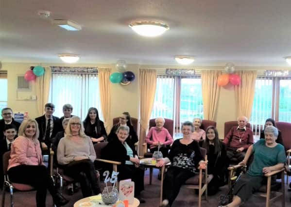 Baillie Court residents and staff with pupils from Braidhurst High School as the complex celebrates 25 years
