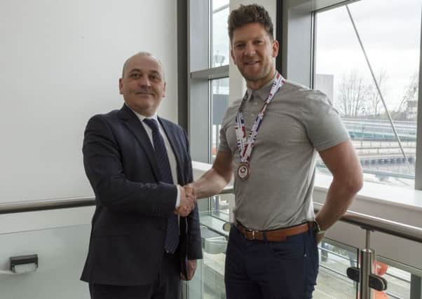 Kirkintilloch curler Ross Paterson is congratulated on his world championship medal by Cllr Billy Hendry, East Dunbartonshire Council Convener of Place, Neighbourhood and Community