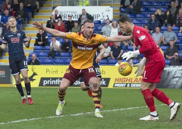 Tom Aldred holds off Ross County's Alex Schalk to make sure a long ball safely reaches Motherwell 'keeper Trevor Carson during Saturday's draw (Picture - Ian McFadyen)
