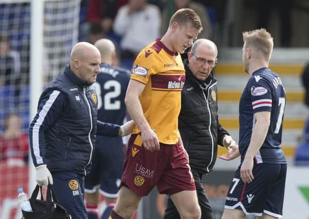 Andy Rose goes off with a suspected broken collarbone (Picture - Ian McFadyen)