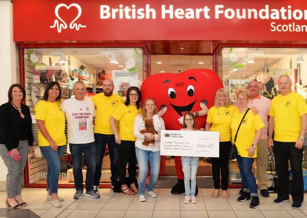 Cheque presentation at British Heart Foundation store in Cumbernauld