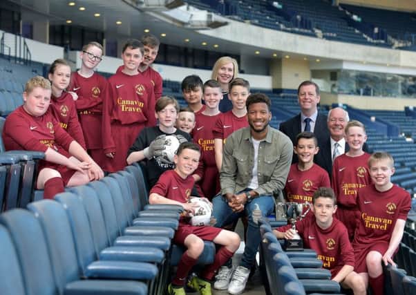 Holy Cross Primary pupils with Myles Hippolyte at Hampden