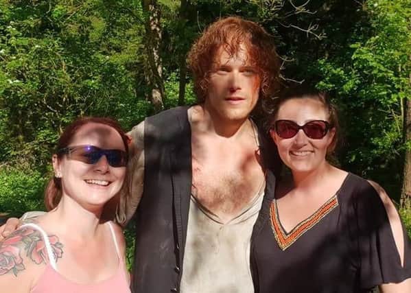 Ann Sweeney (right) and her friend Suzy Smillie with Outlander star Sam Heughan