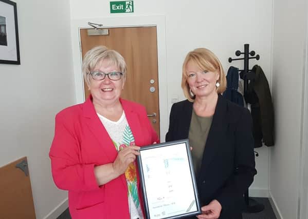 Marion Fellows receiving her award from Sue McClintock of Carers Scotland
