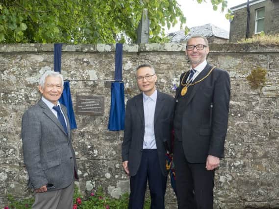 Lam Tran (left) and Trung Le were young men when they arrived in Lanarkshire as refugees Lam is now retired after a long career in social work, Trung is a Business Consultant. Provost Of South Lanarkshire councillor Ian McAllan (right) unveiled the memorial plaque in Carnwath.