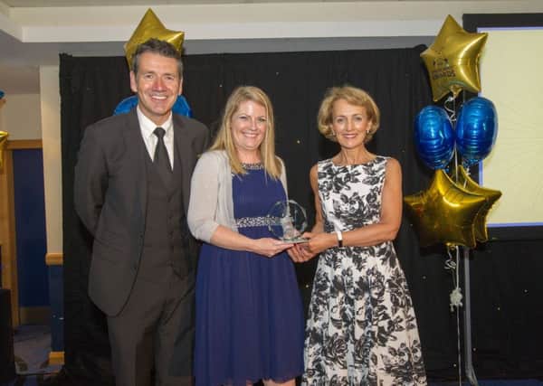 Outstanding Colleague Award winner Lisa Walsh (centre) with host Dougie Vipond and NHS 24s chief executive Angiolina Foster