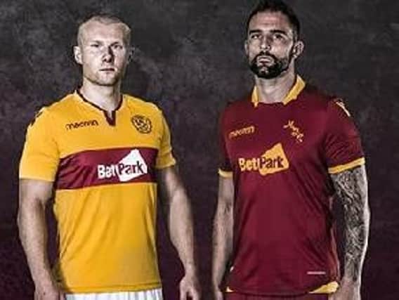 Motherwell stars Curtis Main and Peter Hartley modelling the new home and away kits respectively