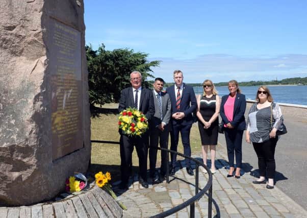 Paying their resepcts at the Piper Alpha Memorial in Strathclyde Park are: (l-r) Cllr Jim Logue, Cllr Shahid Farooq, Cllr Jordon Linden, Cllr Angela Campbell, Cllr Louise Roarty and Martine Nolan