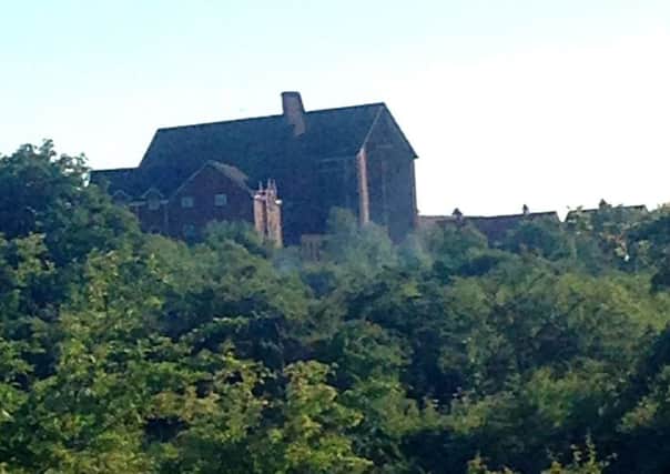 St Flannans Church and wooded area where burning is taking place near to the Forth and Clyde Canal towpath.