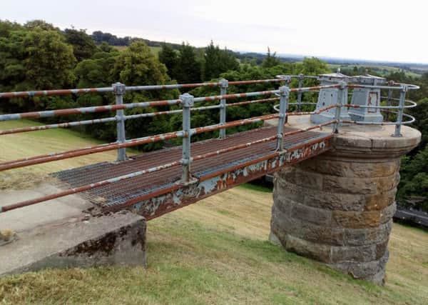 The rusted safety rails on the walkway leading to the tower structure at the Craigmaddie Reservoir, Milngavie.