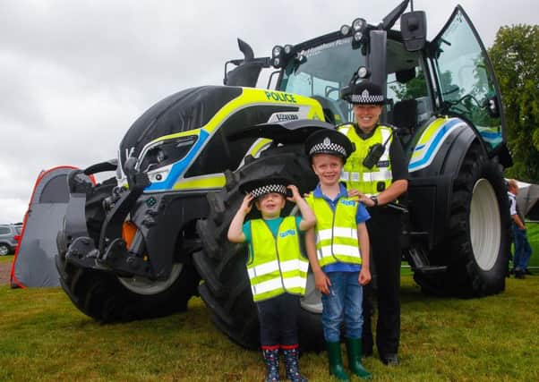 The police tractor with PC Lyndsey McLean, Harry Ratcliffe and his brother  Tom.