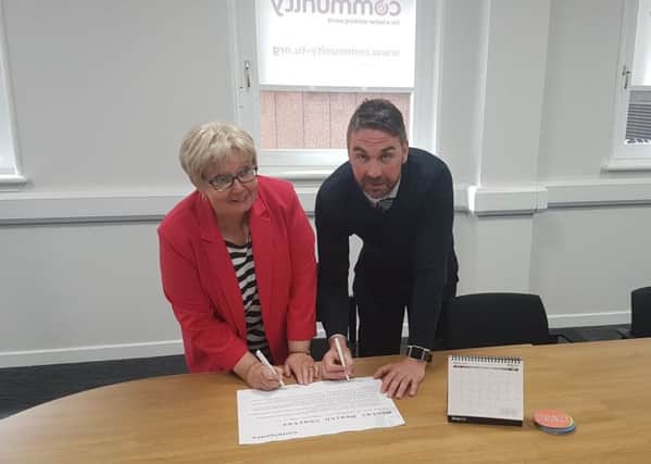 Motherwell and Wishaw MP Marion Fellows with Steve Farrell of the Community as she signs the trade unions Meantal Health Charter, and has encoraged other employers to follow her example