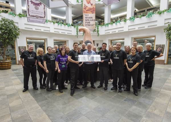 The William Grant & Sons UK team present a cheque to St Andrews Hospice fundraiser Bobby Mason