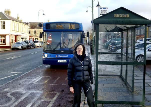 Dr Janet Moxley next to bus stop on Biggar High Street