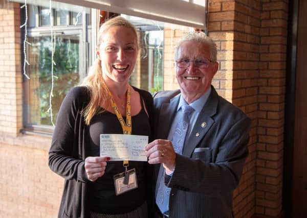 Rotary Club of Cumbernauld president Bobby Johnstone presents a cheque for Â£1632 to Maisie Hamilton of Beatson Cancer Care
