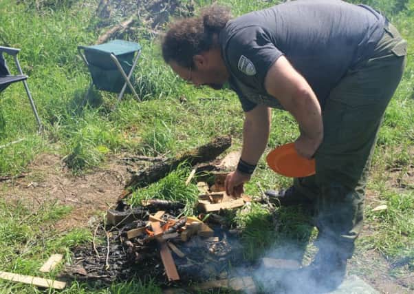 One of a previous courses participants building a fire.