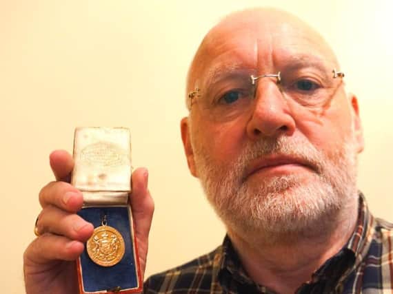 David Copland with medal given to Willie Rankin in 1921