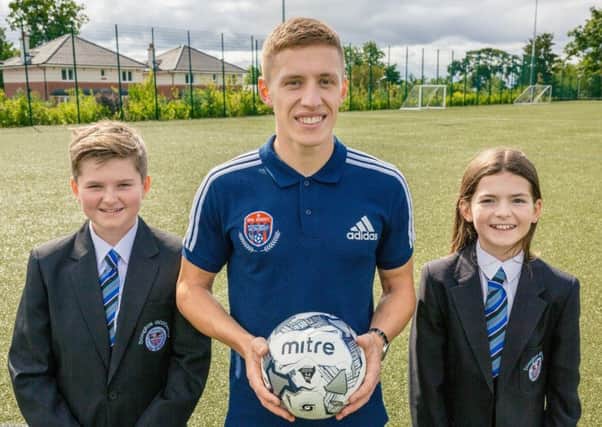 Rangers star Greg Docherty launches his new Football Academy at Douglas Academy, with the help of pupils Reiss Weir and Marnie Sayer