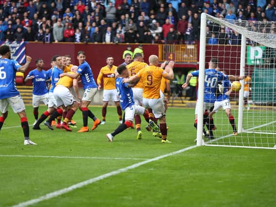 Peter Hartley forces Motherwell's dramatic last gasp equaliser over the Rangers goal-line (Pic by Ian McFadyen)