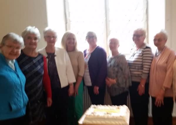 Members of the club ready to cut their special cake