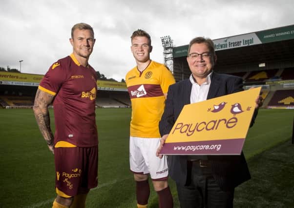Kevin Rogers, CEO of Paycare, at Fir Park with players Richard Tait and Chris Cadden. Pic: SNS