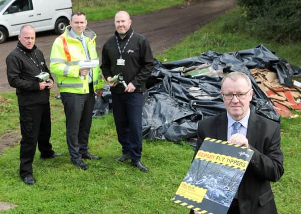 Councillor Michael McPake and staff from the councils environmental protection team highlight an example of flytipping causing an eye sore in North Lanarkshire
