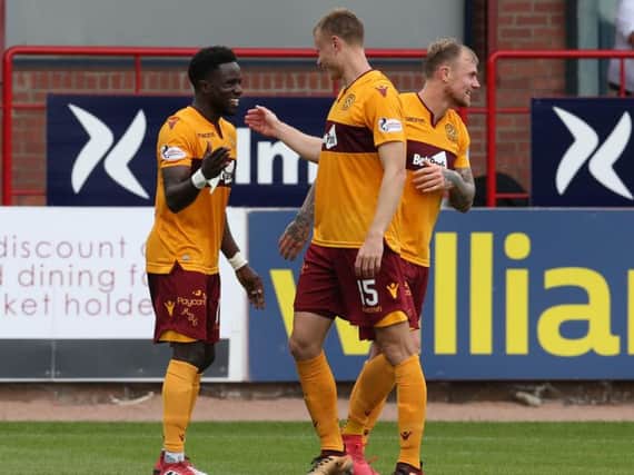 Gael Bigirimana (left) who has been excellent all season, celebrates his goal at Dundee with Andy Rose and Richard Tait (Pic by Ian McFadyen)