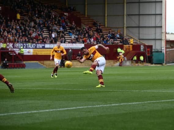 Peter Hartley launches a first half effort at goal