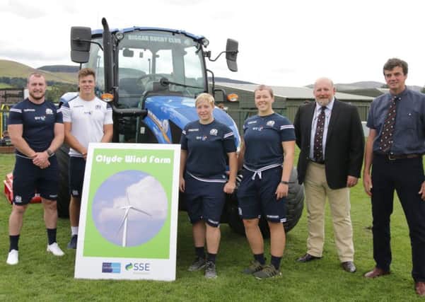 Club officials including President John Bogle and Vice president James Orr proudly show off their new tractor to internationalist guests