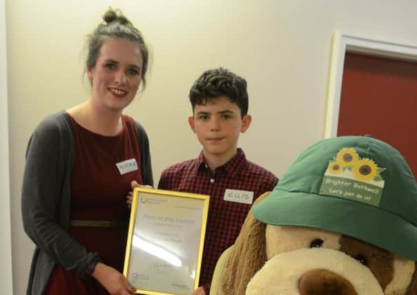 Keep Scotland Beautiful community project officer Heather McLaughlin presents the award to Ellis McNeil