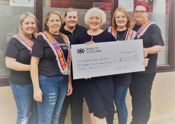 The five ladies from the social committee of LLOL29 hand over the cheque for Â£2255 to Lanarkshire Cancer Care Trust's service manager Margaret Wragg