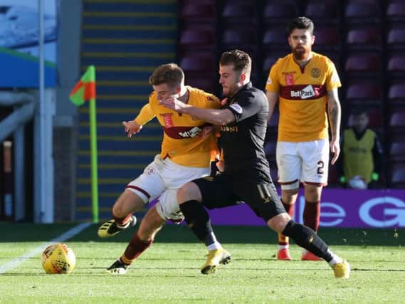 Liam Donnelly (right) looks on as Wells Chris Cadden battles with his Livi brother Nicky (Pic by Ian McFadyen)