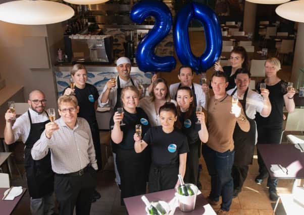 Staff at the Glasgow restaurant celebrate its anniversary.