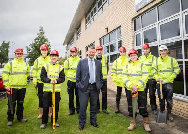 Mark Bryden (fourth left), with Bryan Galloway, construction director for Stewart Milne Homes, and the other new apprentices.