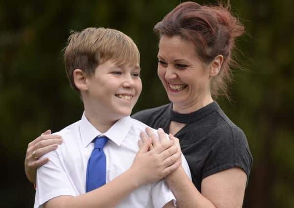 Ex-nurse Amy McCabe with her son Ben outside Glasgow Cowcadden Fire Station highlighting the dangers of fireworks. Ben was just four-years-old when he was scarred for life after a stray firework set his shirt alight. Pic: SWNS