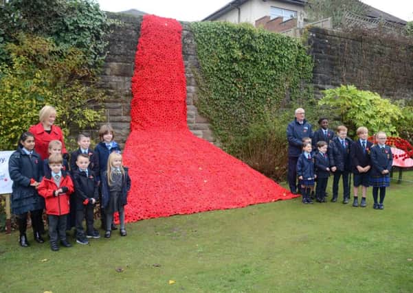 It took around 5000 knitted poppies to create the cascade in Bothwell
