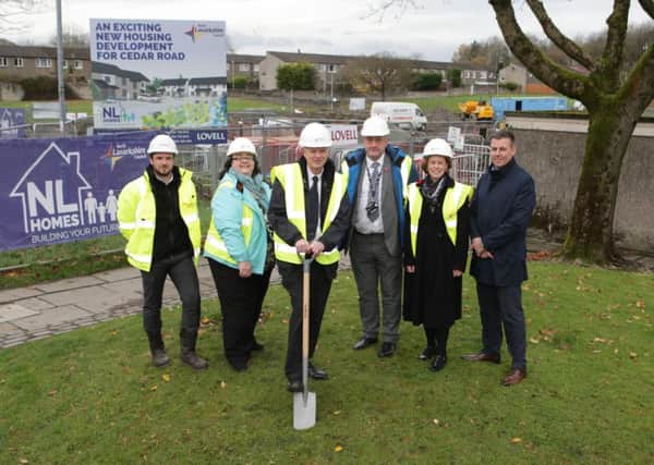 Councillor Allan Graham puts his spade in the ground to symbolically signal the start of the project in Cedar Road, Abronhill