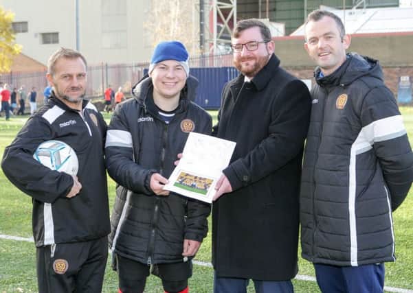 Paul Slater (second, left) receives his signed picture from the MFC Trusts Malky Taylor and David Clark and Motherwell West councillor Paul Kelly (second right)