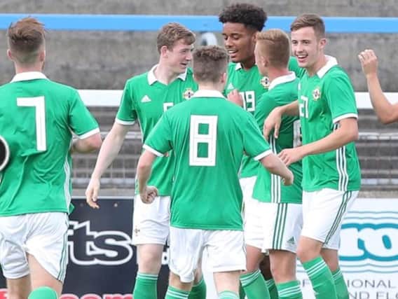 Tom (first right) celebrates a Northern Ireland under-19s goal. The team is bossed by ex-Hearts ace Stephen Frail.
